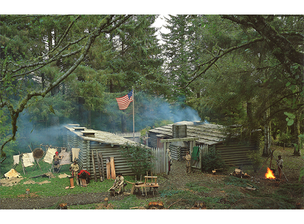 A historical recreation of Fort Clatsop, a wooden small 50 foot by 50 foot fort, is surrounded by rangers in historical clothing working on different projects.