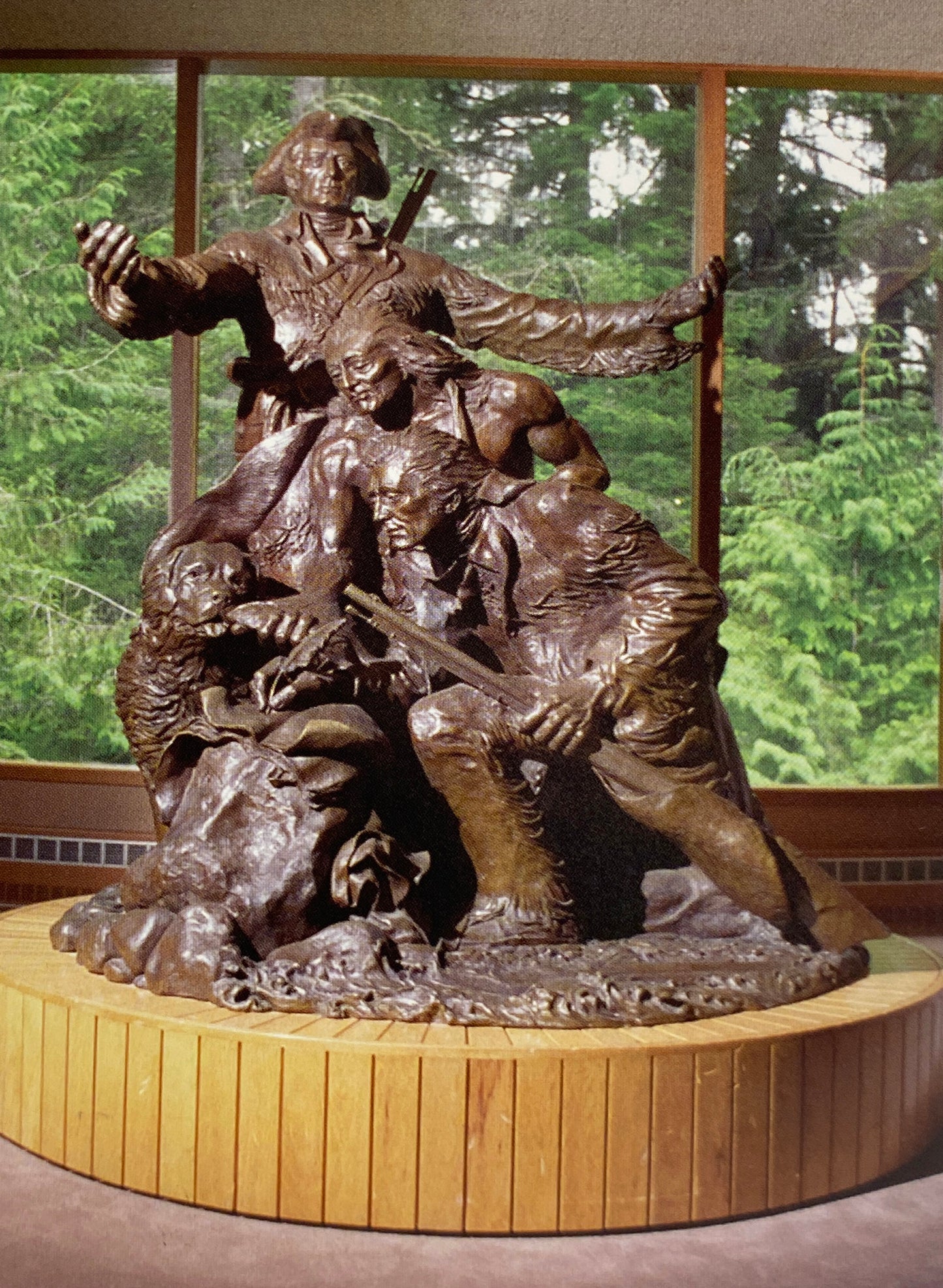 A bronze statue depicting Lewis, Clark, a Native American, and Seaman the dog.