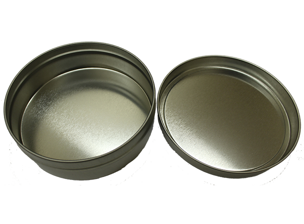 A small round tin container with its lid off