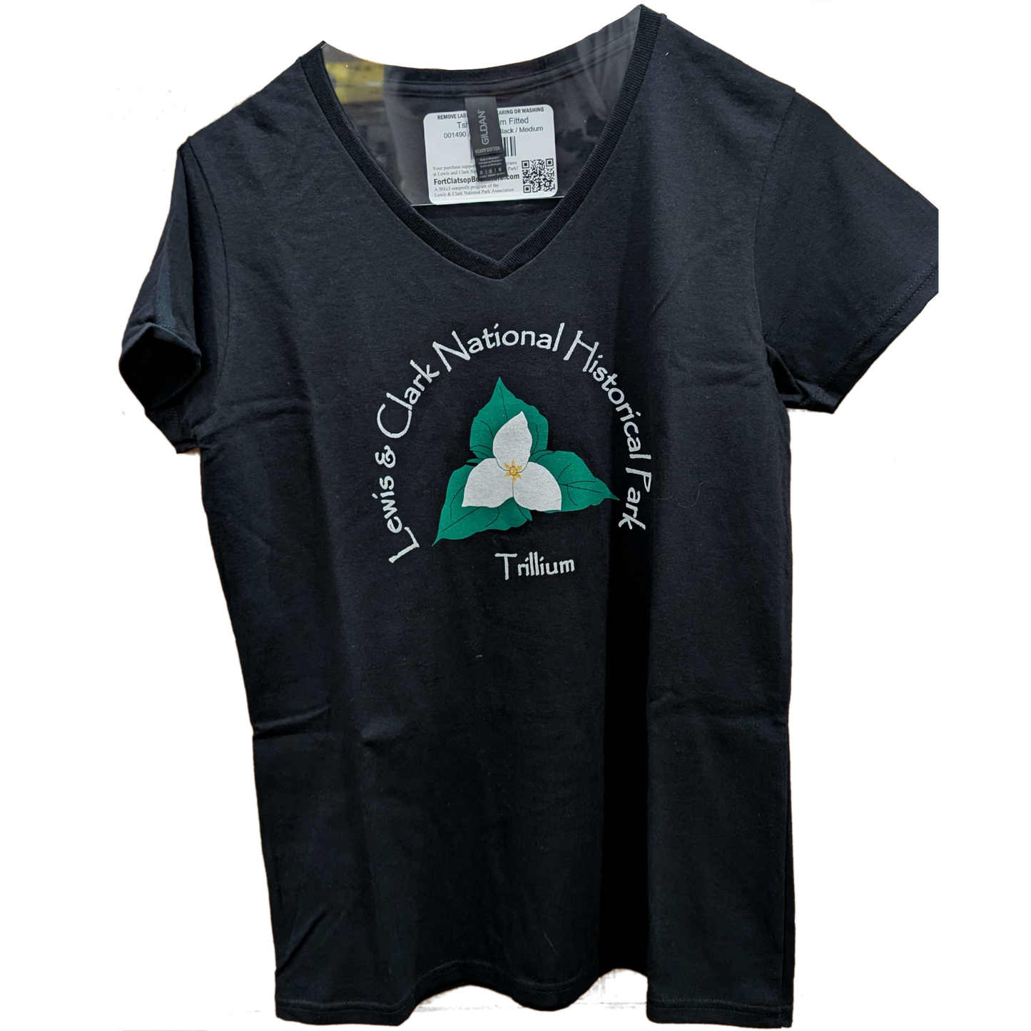 A black V-cut T-shirt with an artistic depiction of a trillium on the front, labelled Trillium below while text arching around it reads "Lewis & Clari National Historical Park"