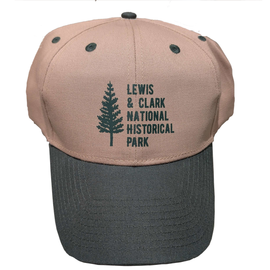 A baseball cap with green brim, beige top, and icon on the front of a large tree with text "Lewis & Clark National Historical Park" beside it.